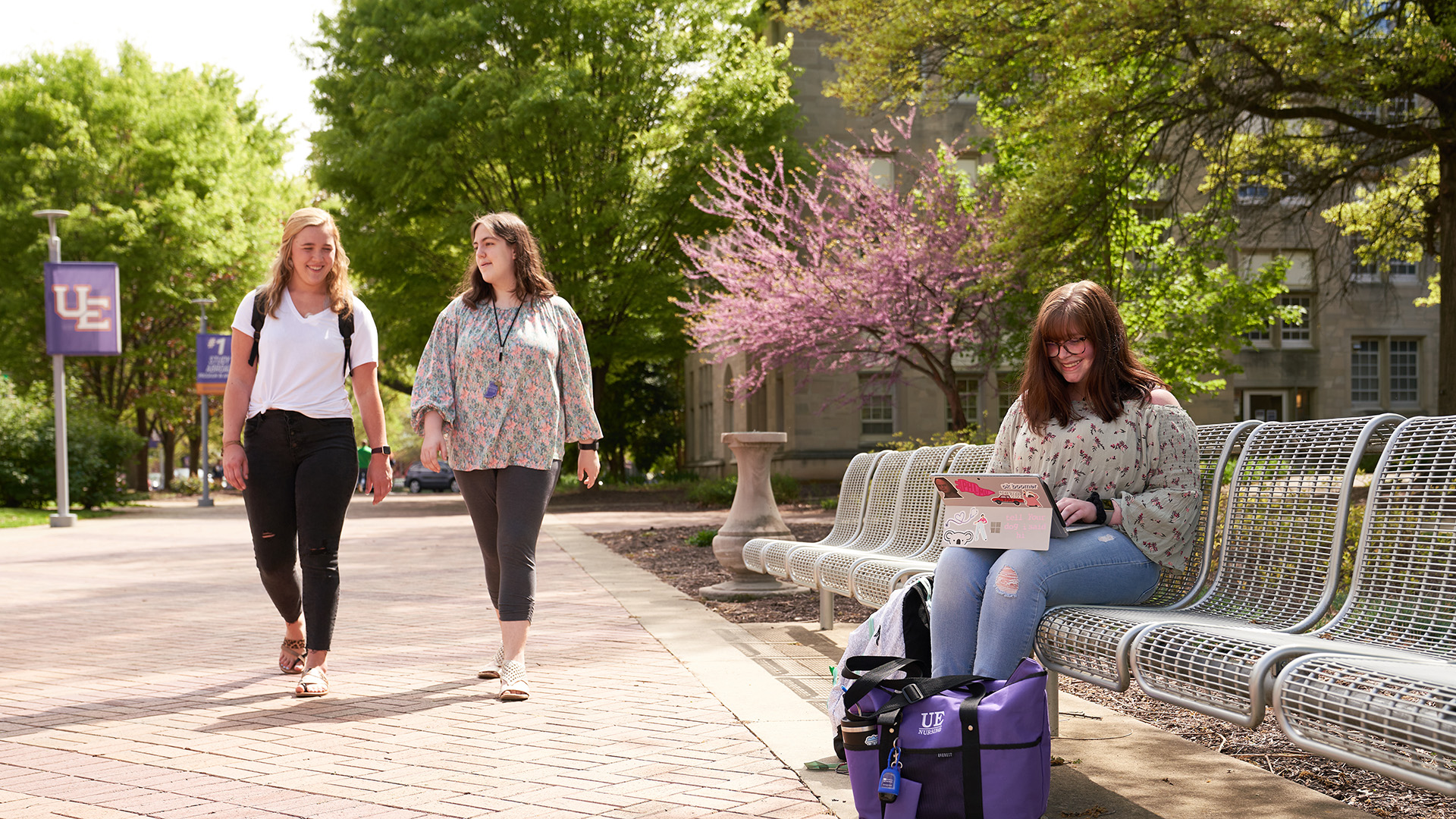 Women on campus walking and sitting