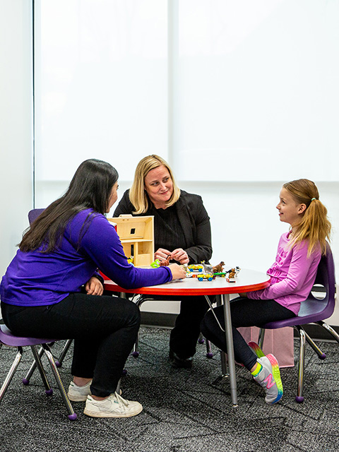 Child patient in room with staff